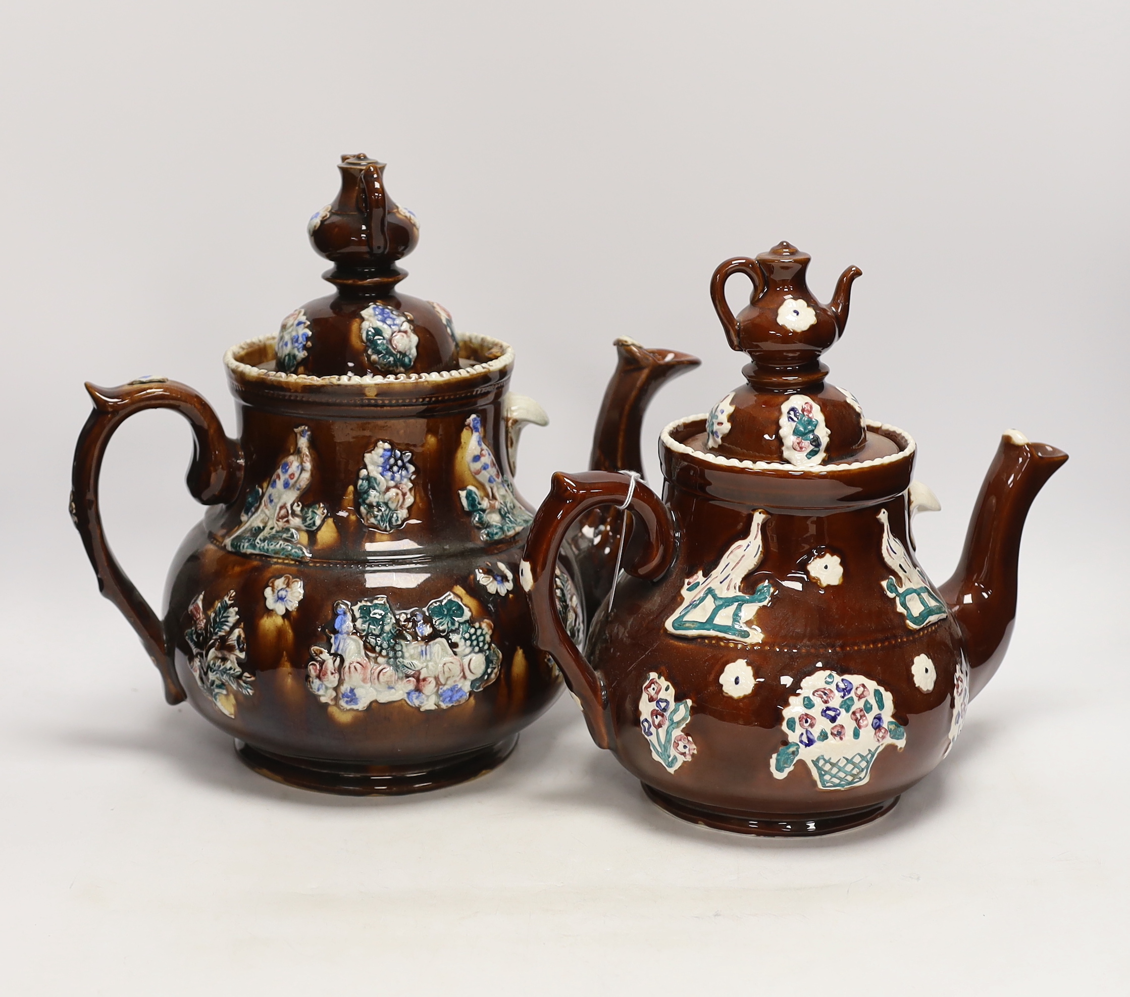 A late 19th century Measham barge ware teapot and cover, 31.5cm high, together with a reproduction teapot in the same style